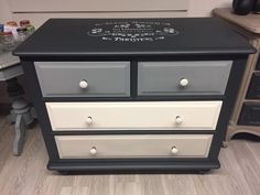 a black and white dresser with writing on it