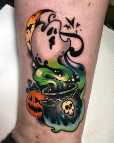 a colorful tattoo on the leg of a person with a pumpkin and caulder