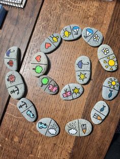 some rocks are arranged in the shape of a circle on top of a wooden table