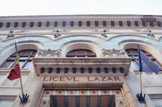 an old building with flags flying in front of it and the name licev lazar