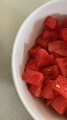 a white bowl filled with watermelon slices