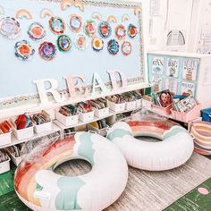 two inflatable floats sitting on top of a table next to bookshelves