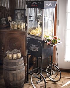 an old fashioned popcorn vending machine with wheels