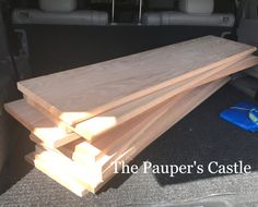 three pieces of wood sitting in the back of a car