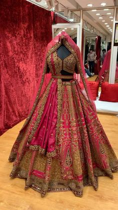 a red and gold bridal gown on display