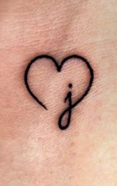 a small heart with an arrow tattoo on the side of her neck and behind it is a musical note