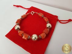 "◎ Sterling silver bracelet made from semi-rustic shaped beads of precious, orange Mediterranean coral. The coral is unique, all natural and hasn't been treated or dyed in any way. Adorned with decorative ball elements, and various spacer beads. Everything is handmade in sterling 925 silver. ◎ Locking length: 18 cm ( 7.1\" ) Silver ball element diameter: 10.5 and 12 mm ( 0.41 and 0.47\" ) ◎ Enter the shop, for more of our jewelry, and matching necklace ;) ◎ - - - - - - - - - - - - - - - - - - - Coral Red Beaded Bracelets As Gift, Coral Beaded Bracelets For Gifts, Artisan Orange Beaded Bracelets As Gift, Artisan Orange Beaded Bracelet For Gifts, Artisan Orange Beaded Bracelet As Gift, Orange Large Beads Bracelet, Artisan Orange Beaded Bracelet Gift, Coral Red Coral Beaded Bracelets, Orange Jewelry With Silver Beads As A Gift