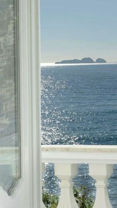 an ocean view from the balcony of a house