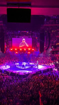 an auditorium full of people watching a concert