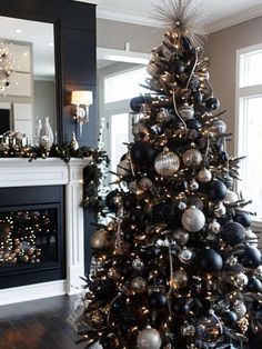 a black and silver christmas tree in a living room