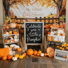 a baby shower is decorated with pumpkins and other decorations