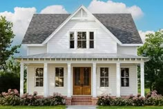 a white two story house with porches and windows on the first floor is shown