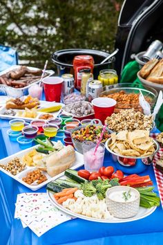 a blue table topped with lots of food