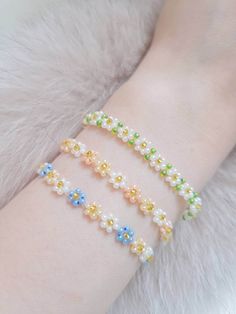 "Summer Daisy Flower Bracelets (Ring is optional) Bracelet Size Reference --Fits the US average wrist size: 6.5\" - 7\" (up to 7.5'') --Bracelet Length: 8 inches long including chains --If you would like a custom size, please leave a note at checkout. Ring Size Reference (Approxi) US 5 - 50 mm US 7 - 55 mm US 9 - 60 mm US 11 - 65 mm Care Instructions --Recommend avoiding contact with water (Remove it before getting in the shower or cleaning) --For longevity, the jewelry should be treated gently (No stretching or playing) Please Note --Due to the nature of handmade items, the product you receive may differ slightly from the picture. --Avoid playing with them as it will break. --Due to the fact that every piece of jewelry is made to order cancellations, returns or exchanges are not accepted. Adjustable White Bracelet With Flower Decoration, White Flower Bracelets For Wedding, Flower Decoration Wedding Bracelets, White Flower Charm Bracelet For Wedding, White Wedding Bracelets With Flower Charm, White Wedding Bracelet With Flower Charm, Adjustable Multicolor Beaded Bracelets For Wedding, Adjustable Flower Bracelet With Flower Decoration, Adjustable Flower Pearl Bracelet