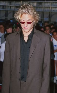 a man with curly hair and sunglasses at an event