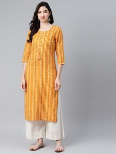 This Yellow Stripe Print Straight Kurta from Piroh exhibits tassels on placket, coconut buttons and off white kantha detail on neck and sleeves along with Round Neck & 3/4th Sleeves. Tailored from Cotton. Product Length: 46 Inches. Description Size - Measuring Unit  :  Regular Size                                 :   ( S, M, L, XL, XXL )  Shape Type                    : Straight t Length Type                   :  Calf Length Color                                :  Yellow Ideal For Festival Straight Kurta With Back Tassel Tie-up, Spring Long Sleeve Kurta With Tassels, Traditional Cotton Kurta With Back Tassel Tie-up, Cotton Straight Kurta With Tassels, Cotton Kurta With Tassels For Navratri, Diwali Tassel Straight Kurta, Diwali Long Sleeve Kurta With Tassels, Spring Traditional Kurta With Tassels, Traditional Spring Kurta With Tassels