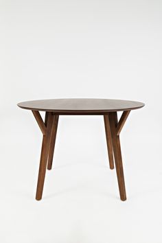 a wooden table sitting on top of a white floor