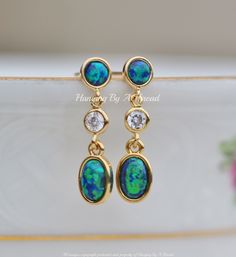 "Gorgeous new earrings made using premium opal components and CZ jewels. The earrings feature 5mm opal stud, that is blue green in color. It connects to a bezel CZ jewel, and an opal charm in the same teal blue color. All components are 14K gold plated and are nickel and lead free. A stud is located at the upper back of the top link. Total earring length is 7/8\". ** Nickel and lead free"