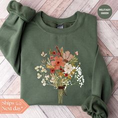 All of our Bouquet hoodies are handmade to order on an ultra soft crewneck that will quickly become your go to apparel item! You will never want to take it off! Our Floral sweatshirts are handmade to order with eco-friendly water based ink that feels good and lasts longer! ♥The details♥ This unisex sweatshirt is crafted from soft, breathable fabric for ultimate comfort. Printed with an eco-friendly water-based ink, this sweater not only looks great but also supports sustainable practices. The unisex sizing allows for a versatile fit, but we suggest sizing up for a more relaxed look. To keep your crewneck looking its best, we recommend washing it on cold and either hanging it to dry or tumble drying it on low heat. Be sure to avoid ironing directly on the design to preserve the vibrant prin Green Crew Sweatshirt For Spring, Spring Crew Neck Sweatshirt For Gift, Spring Crew Neck Sweatshirt, Crew Neck Sweatshirt For Spring, Spring Cotton Sweatshirt Gift, Spring Gift Long Sleeve Sweatshirt, Spring Long Sleeve Sweatshirt, Flower Shaped Relaxed Fit Sweatshirt For Fall, Relaxed Fit Flower Sweatshirt For Fall