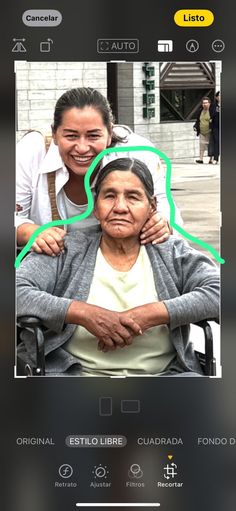 an old woman sitting in a chair with her arm around another woman's shoulder