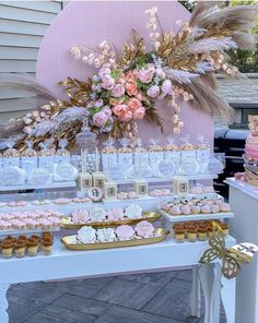 a table topped with lots of cakes and cupcakes