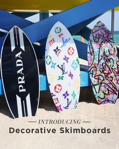 three surfboards are lined up on the beach with words describing decorative skimboards