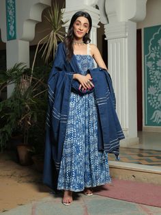 Farah smoked printed blue anarkali suit with pant and dupatta set is perfect for a festive season . Cotton cambric fabric makes it perfect for summer weather. Mirror work shell strap with gota detailing on the dupatta give the set a classic look. Product has lining. Pant has two side pockets, back elasted waistband. Cold wash and Dry clean only.Type of Work: Hand Block/ Solid Fit: Fitted at bust Model Height: 5'4 Measurements: Kurta- 52.25" Pants- 36.25" Dupatta- 95.75" SKU#: 11703066BL Disclaim Blue Cotton Anarkali Set With Bandhani Print, Bohemian Blue Cotton Anarkali Set, Festive Blue Batik Print Kurta, Anarkali Cotton Salwar Kameez In Indigo, Cotton Blue Bandhani Print Palazzo Set, Blue Cotton Bandhani Print Palazzo Set, Blue Cotton Anarkali Palazzo Set, Blue Anarkali Cotton Palazzo Set, Blue Cotton Anarkali Set With Traditional Drape