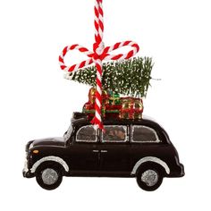 a car with a christmas tree and candy canes on top