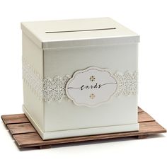 a white box with lace trimming on the sides and a label that says cards