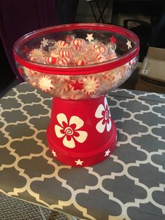 a bowl filled with candy sitting on top of a table