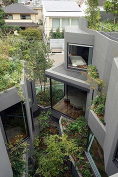 an aerial view of some buildings with plants growing on the roof and in between them