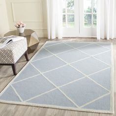 a blue and white rug in a living room