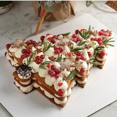 a white plate topped with slices of cake covered in icing and cranberries