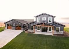 an aerial view of a two story house in the middle of a large open field