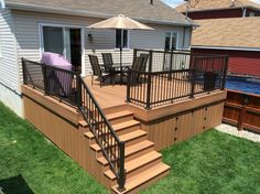 a wooden deck with chairs and an umbrella