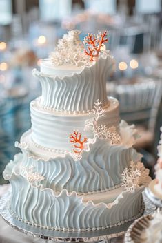 a three tiered white cake sitting on top of a table