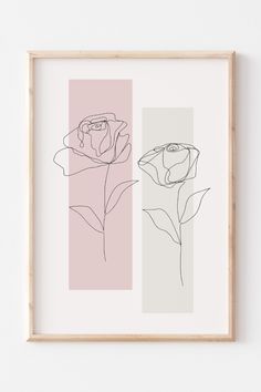 two framed flowers on a wall next to each other