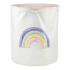 a white pot with a rainbow embroidered on the front and bottom, sitting in front of a white background