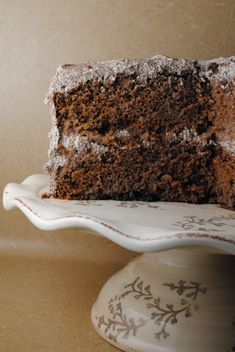 a slice of chocolate cake sitting on top of a white plate