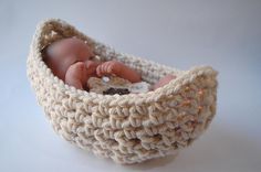 a baby doll in a crocheted basket with the words pattern only on it