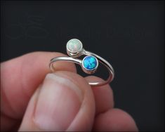 This gorgeous ring is made using two manmade gemstones or synthetic opals, that have been set in tube bezels. This ring is slightly adjustable. Handcrafted from sterling silver. Please refer to photos for birthstone and opal color choices. • sold individually• sterling silver, manmade gemstones, synthetic opal• stones: 4mm• band width: 1.3mm Don't know your ring size? Purchase a Reusable Ring Sizer *This is a made to order item. Please check the announcement at the top of the page for current pr Adjustable Sterling Silver Opal Promise Ring, Adjustable Nickel-free Opal Ring For Anniversary, Adjustable Nickel-free Sterling Silver Opal Ring, Tube Setting, Dual Birthstone Ring, Best Friend Rings, Mother's Ring, Friend Rings, Mother Rings