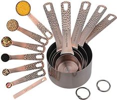 stainless steel measuring spoons and measuring cups are arranged in a circle on a white background