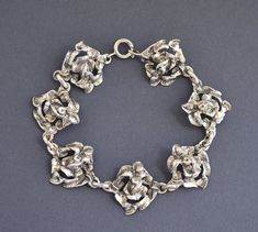 Antique hand crafted 835 silver rose flowers bracelet. Length 19 cm (7.5"), Width 2.1 cm (0.8") Weight 14.5 grams Hallmarked: 835 for European silver Nice vintage condition. The bracelet is closing securely with a spring ring clasp. Will be delivered by tracked mail. Thank you for looking. Please see my other items. Formal Silver Jewelry With Rose Details, Vintage Silver Jewelry With Roses, Floral Bracelet, Silver Roses, Chain Link Bracelet, Chain Link, Spring Rings, Rose Flower, Bangle Bracelets