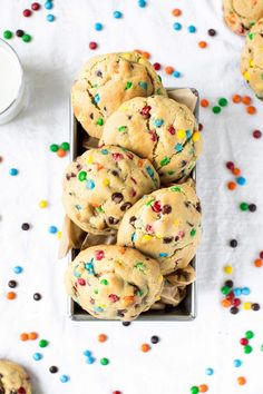 chocolate chip cookies with sprinkles and a glass of milk on the side