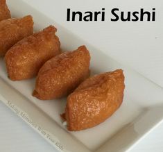 four pieces of food on a white plate with the words inari sushi written above it