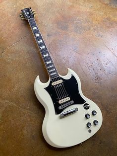 an electric guitar sitting on top of a wooden floor