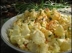 a bowl filled with potatoes sitting on top of a table