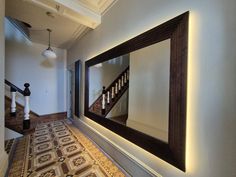 This extra-large wall mirror will suite either contemporary or traditional interior styles. The grand frame made in cherry and finished in dark oak stain oversized mirror is certainly a real showstopper. With engraved Greek key pattern, it gives this mirror an awe - inspiring finish. The rectangular frame dresses the wall, adding elegance and a sense of spaciousness Cleverly incorporated led lights add a warm and cosy glow to the frame and the hallway. Hallway Mirror Entrance, Extra Large Wall Mirrors, Mirror Stairs, Extra Large Mirrors, Long Mirror, Mirror With Led Lights, Large Wall Mirror, Greek Key Pattern, Oak Stain