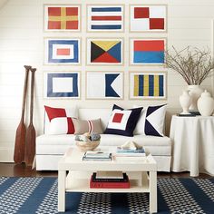 a living room filled with furniture and pictures on the wall above it's coffee table