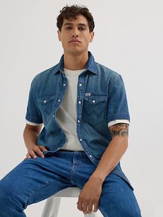 CLASSIC STYLE MADE MODERN Offering a classic look with unlimited potential, our men’s short-sleeve Western denim shirt will instantly elevate your everyday rotation. It’s crafted from 100% cotton for long-lasting quality and washed for softness. This collared shirt comes with two chest pockets with flaps, pearl snaps, and our signature ‘W’ embroidery. It features a comfortable fit through the shoulders and a regular fit through the body for a look that feels very off-duty and put-together all at Western Denim Shirt Men, Mens Summer Outfits, Western Denim Shirt, Denim Shirt Men, Wrangler Shirts, Short Sleeve Dress Shirt, Summer Denim, Shirt Dress Style, Collared Shirt